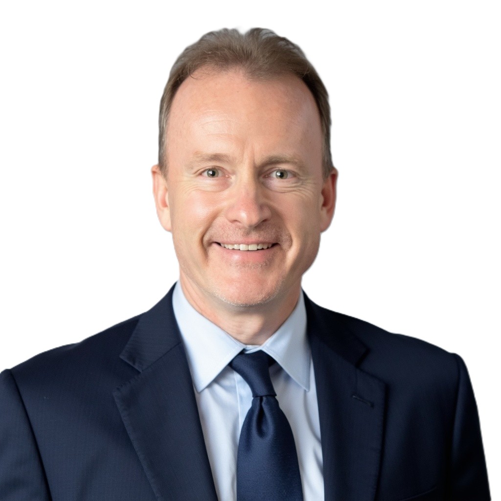 a man wearing a suit and tie smiling at the camera